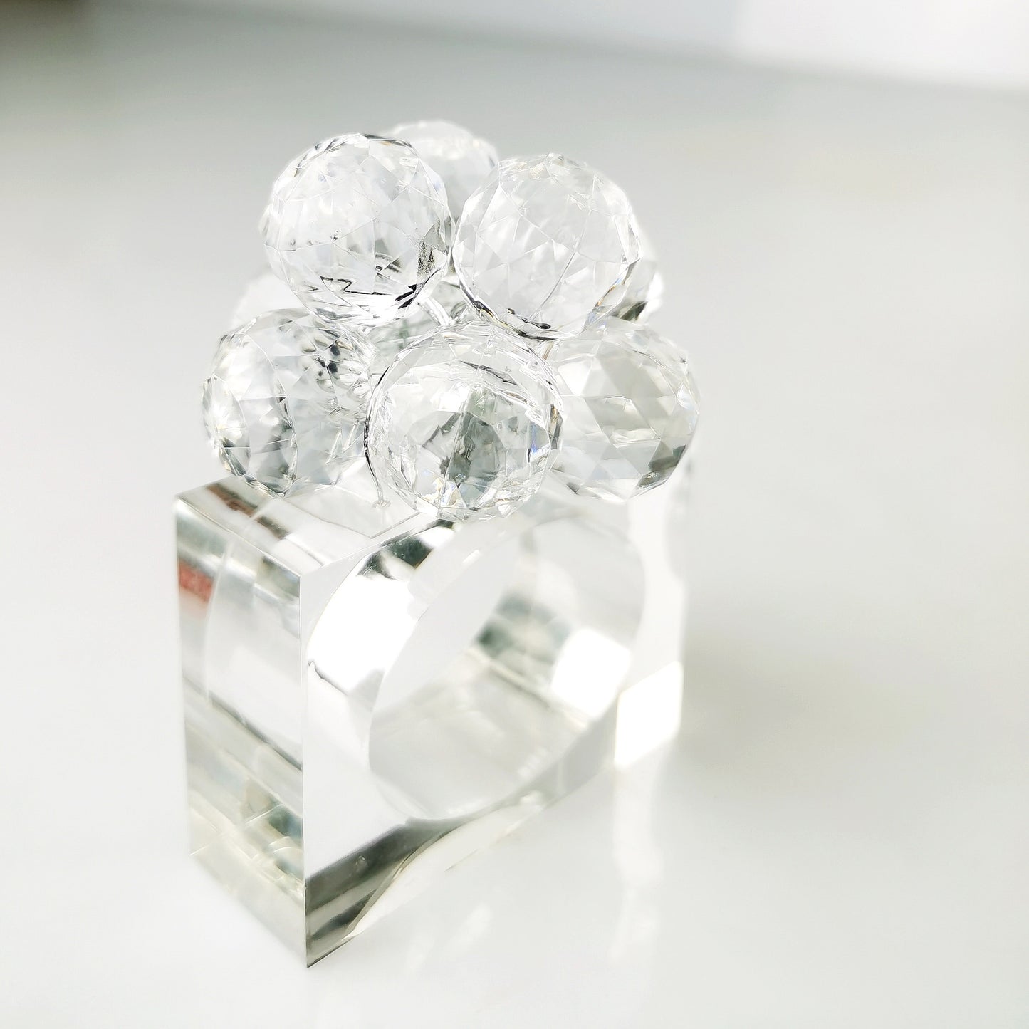 Clear crystal napkin ring on a white background